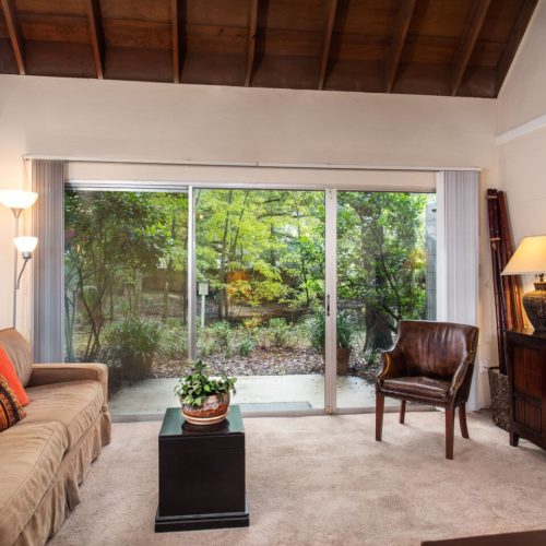 View of furnished living room with glass door leading out to a patio.